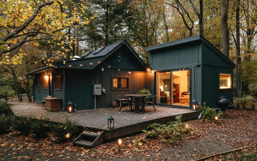 A small cabin among tall evergreen trees