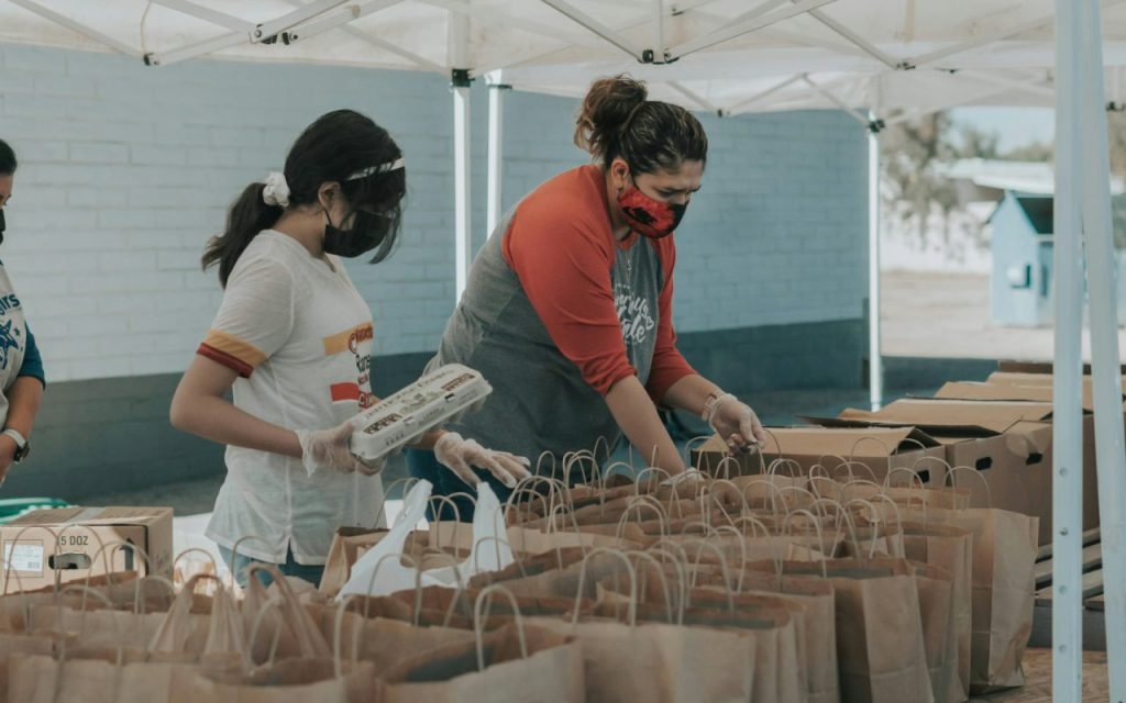Volunteers packing bags of food at a community center