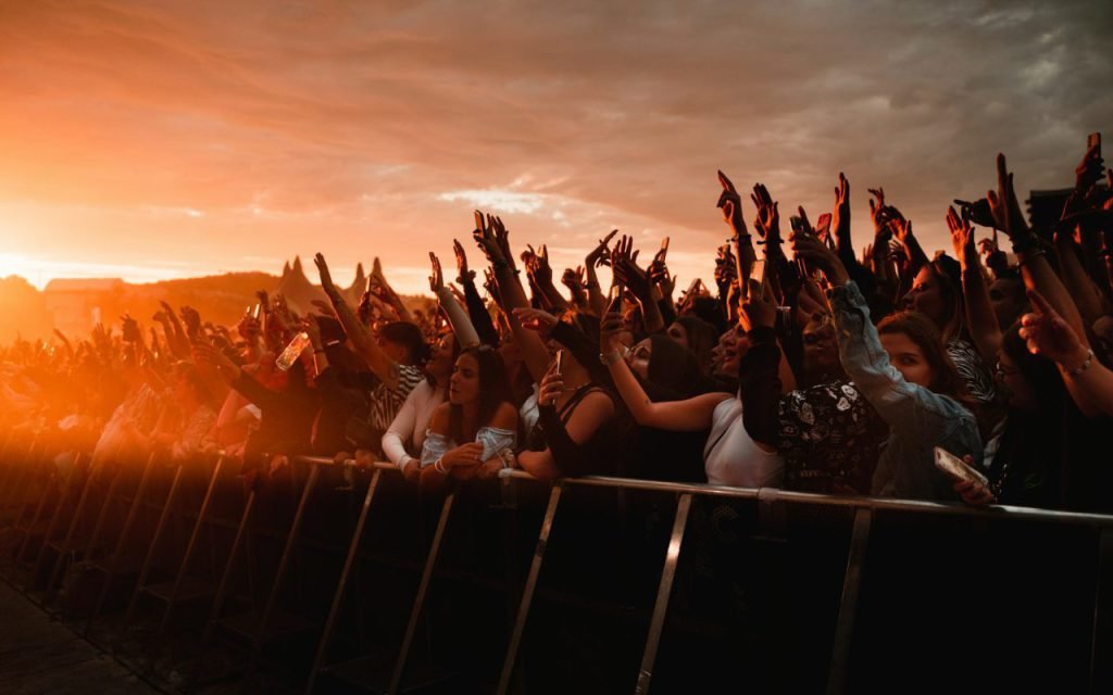 A festival crowd in golden late-afternoon light