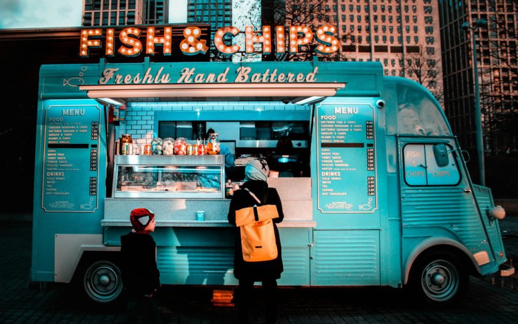 A small outdoor food stand serving customers