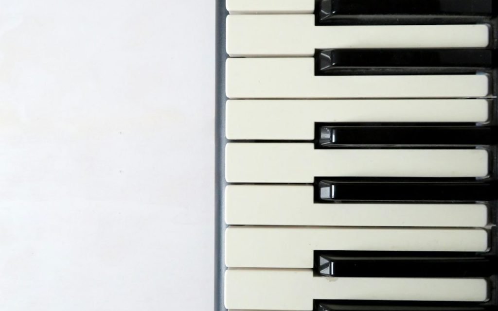 A close-up of piano keys in low light