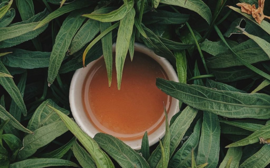 Steaming cup of tea on a windowsill in soft morning light