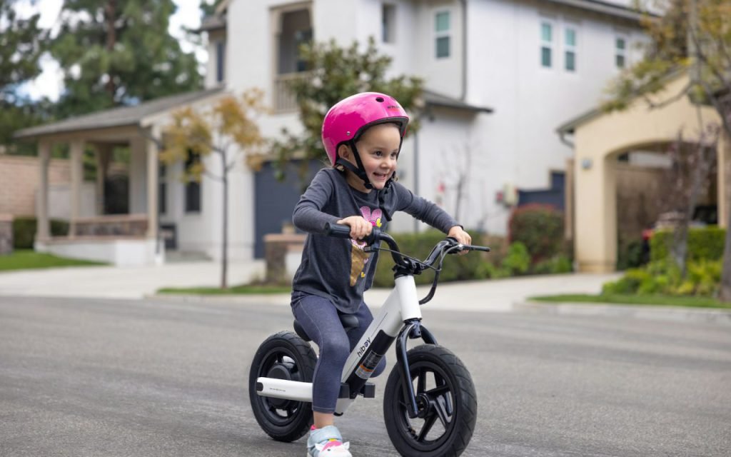 A young girl riding a bicycle on a neighborhood street
