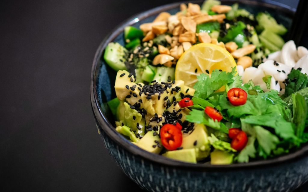 A colorful bowl of fresh salad with vegetables and greens