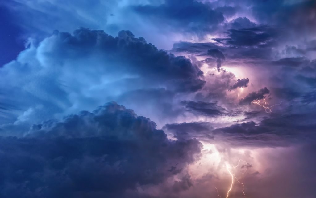Dark, towering storm clouds building over the land