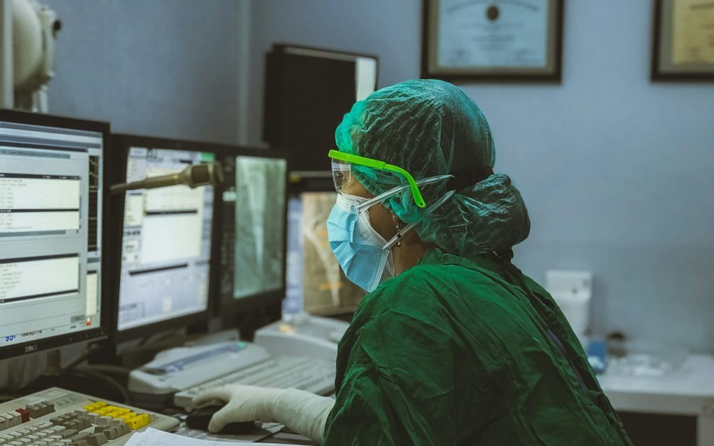 A surgeon in scrubs preparing for an operation