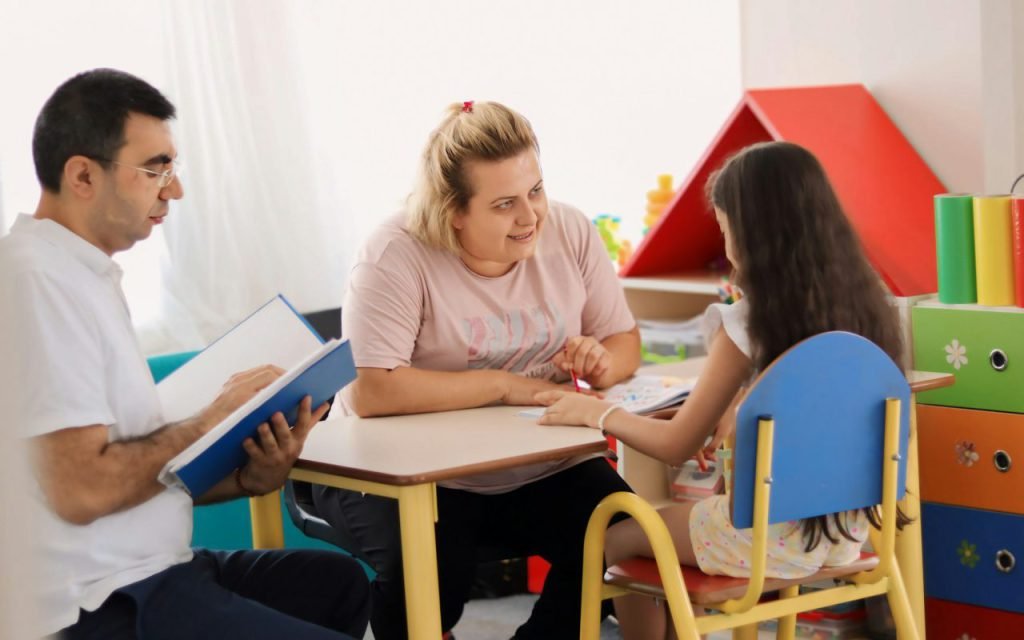 A parent and children reading books together