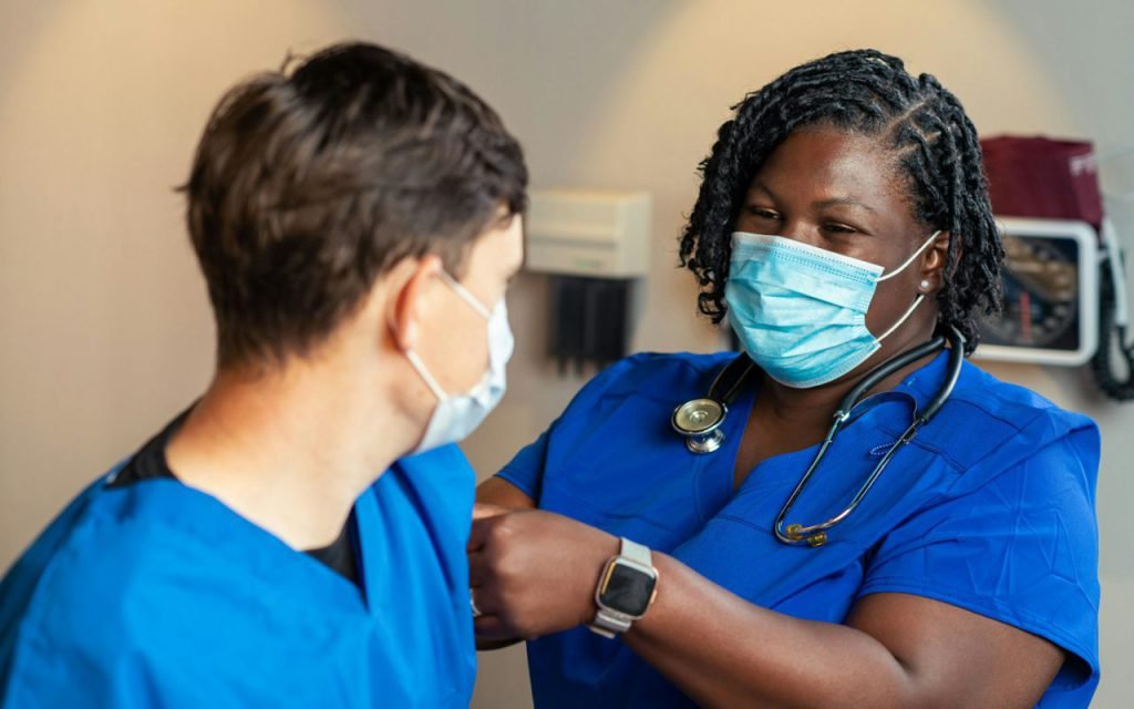 Nurse checking a person's blood pressure with a cuff